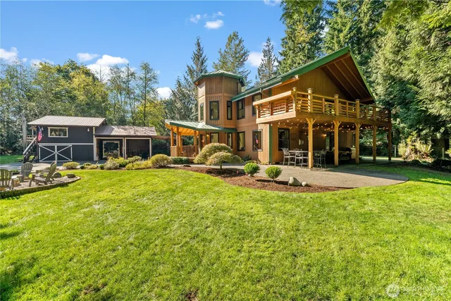 a view of a house with a yard patio and swimming pool