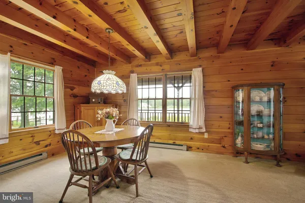 a view of a dining room with furniture and window