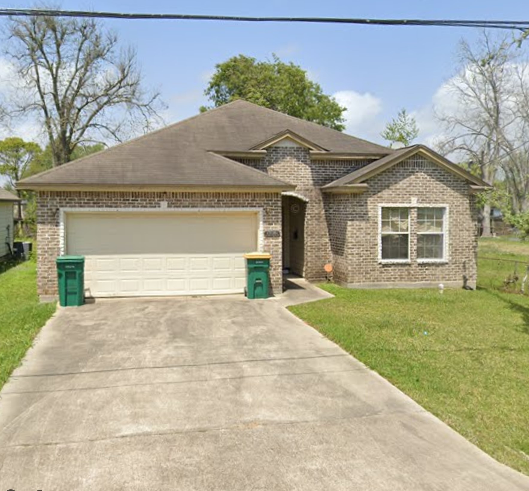 1904 Kansas Street La Marque, TX 77568 - Photo 1 of 20 a front view of a house with a yard and garage