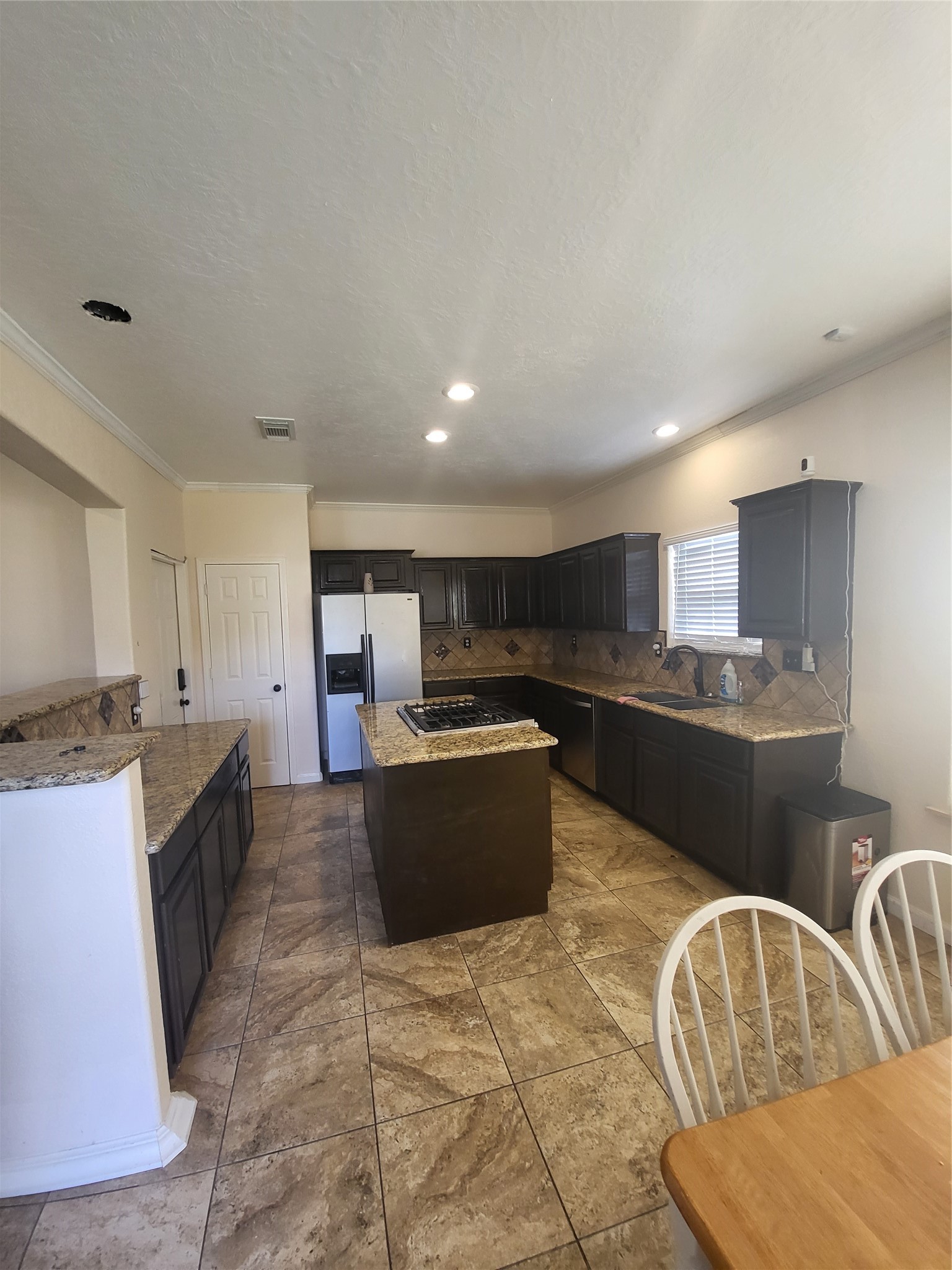 1904 Kansas Street La Marque, TX 77568 - Photo 5 of 20 a large kitchen with kitchen island granite countertop a sink and a stove