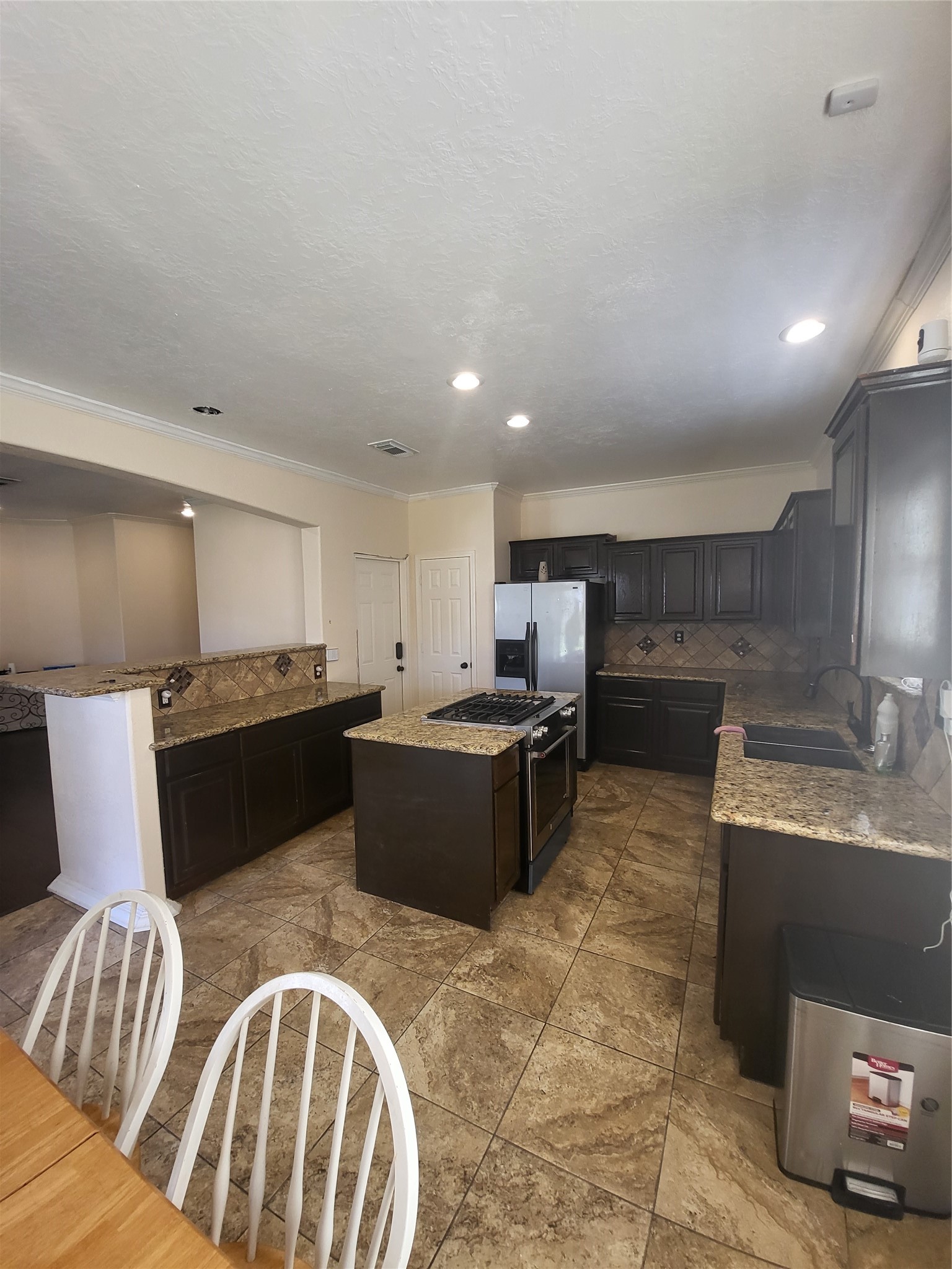 1904 Kansas Street La Marque, TX 77568 - Photo 6 of 20 a large kitchen with a counter top space a sink stainless steel appliances and cabinets