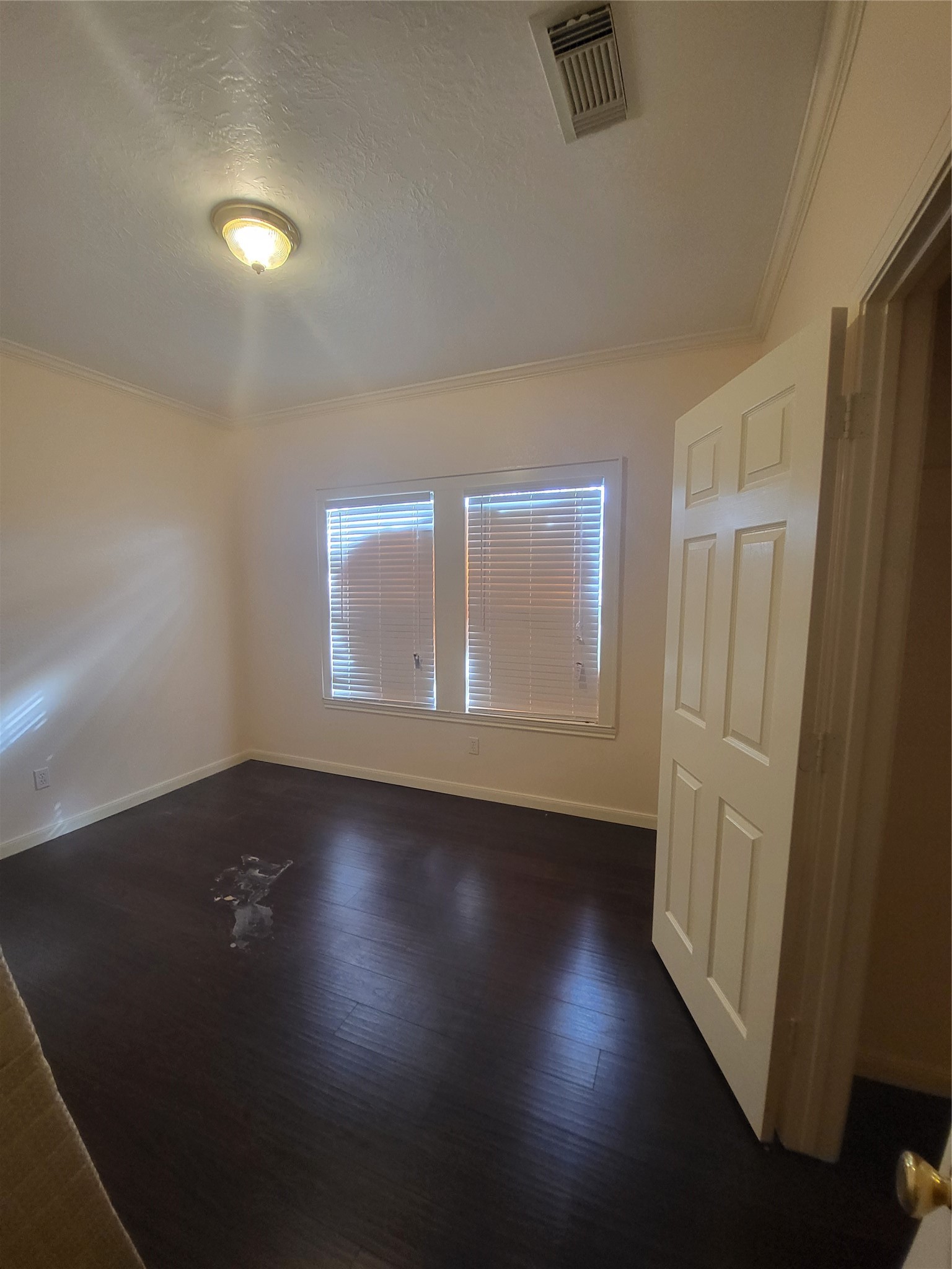 1904 Kansas Street La Marque, TX 77568 - Photo 10 of 20 an empty room with wooden floor and windows