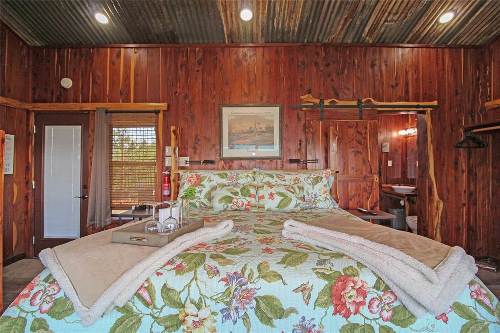 7304 Shady Lane Scurry, TX 75158 - Photo 20 of 39 Wood-paneled room featuring a corrugated metal ceiling with recessed lighting