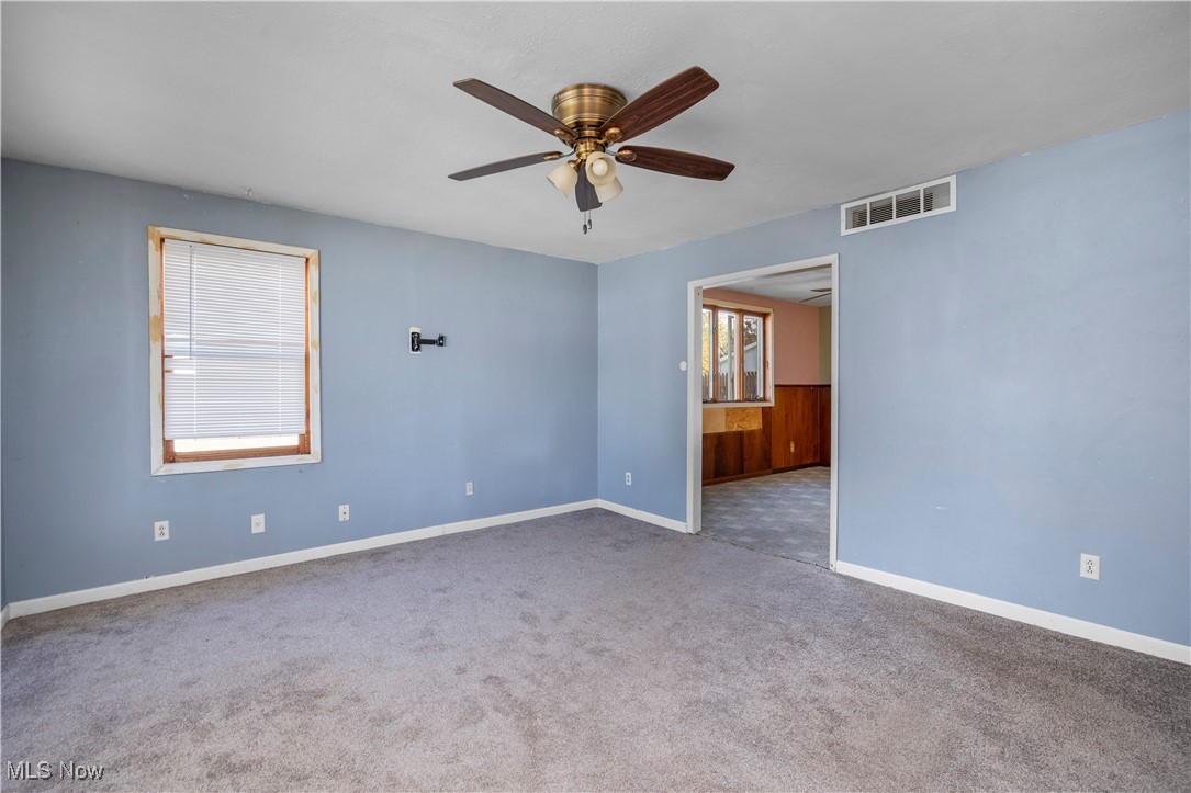 6927 North Wildacre Road Curtice, OH 43412 - Photo 11 of 44 Empty room featuring carpet floors and a ceiling fan