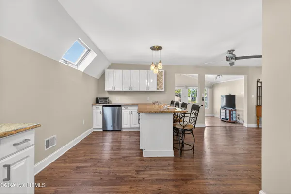 a living room with furniture and a walk in closet
