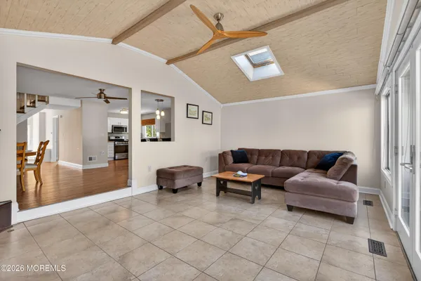 a bedroom with a bed a dresser and chair