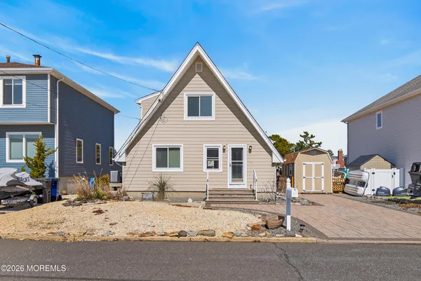 a front view of a house with large windows