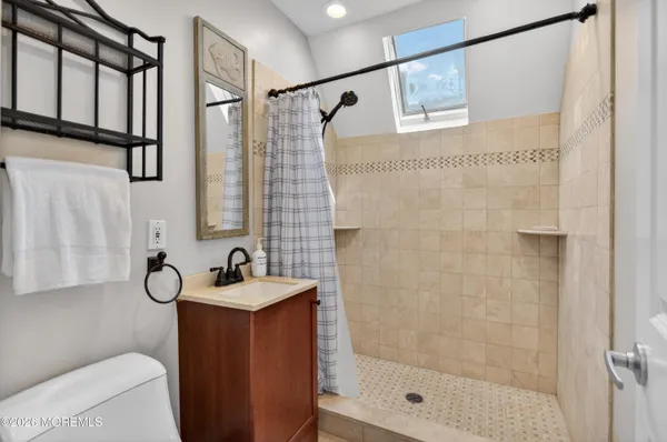 a spacious bathroom with a double vanity sink and a mirror