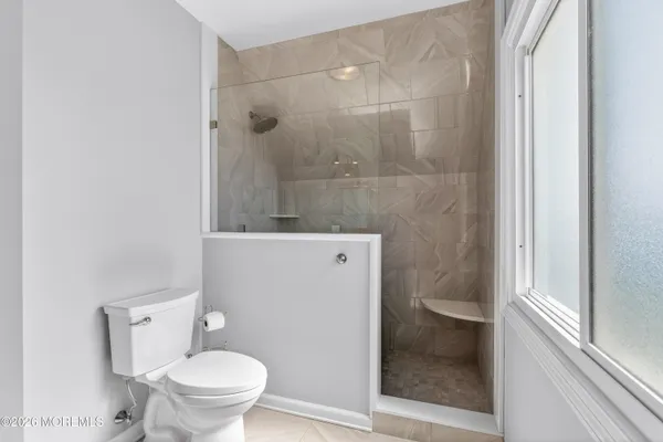 a view of a patio with table and chairs under an umbrella