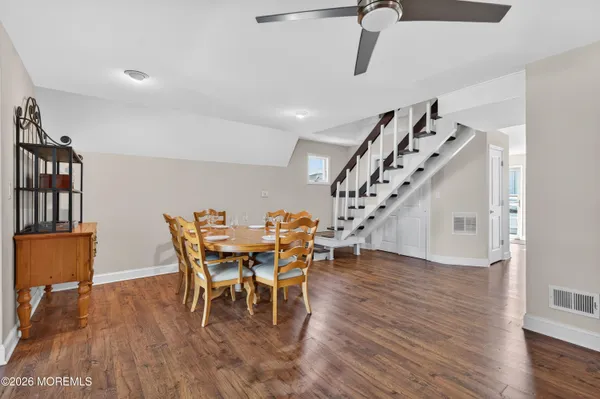 a view of a dining room with furniture and wooden floor