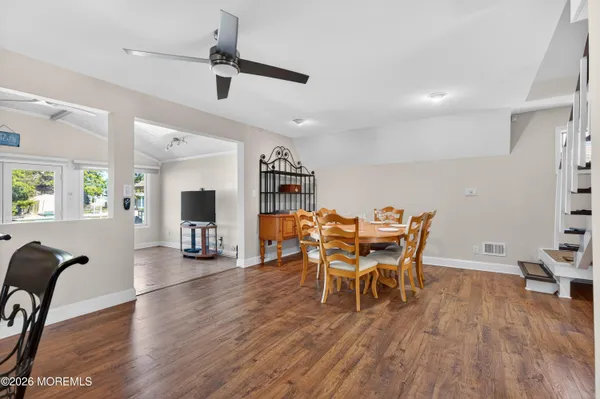 a view of a dining room with furniture and wooden floor