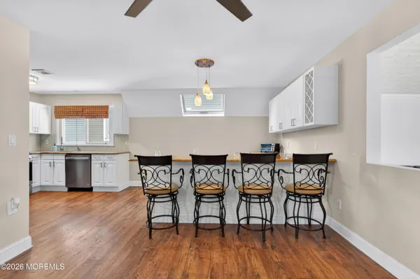 a kitchen with kitchen island granite countertop a sink a counter space stainless steel appliances and cabinets