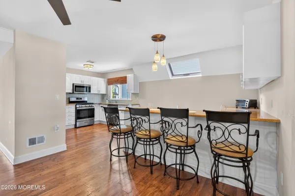 a kitchen with granite countertop a refrigerator stove and microwave