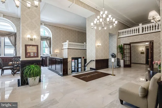 a living room with fireplace furniture and a chandelier