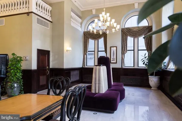 a view of a dining room with furniture and chandelier