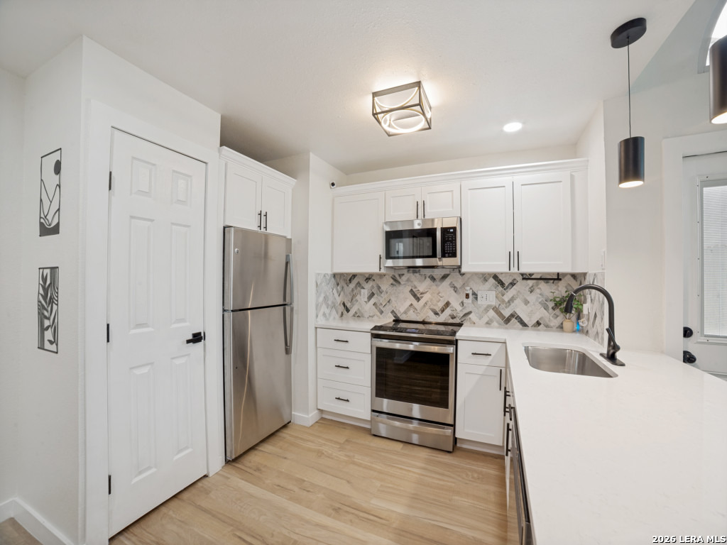 3439 Ridge Ranch San Antonio, TX 78247 - Photo 10 of 25 a kitchen with stainless steel appliances white cabinets and a refrigerator