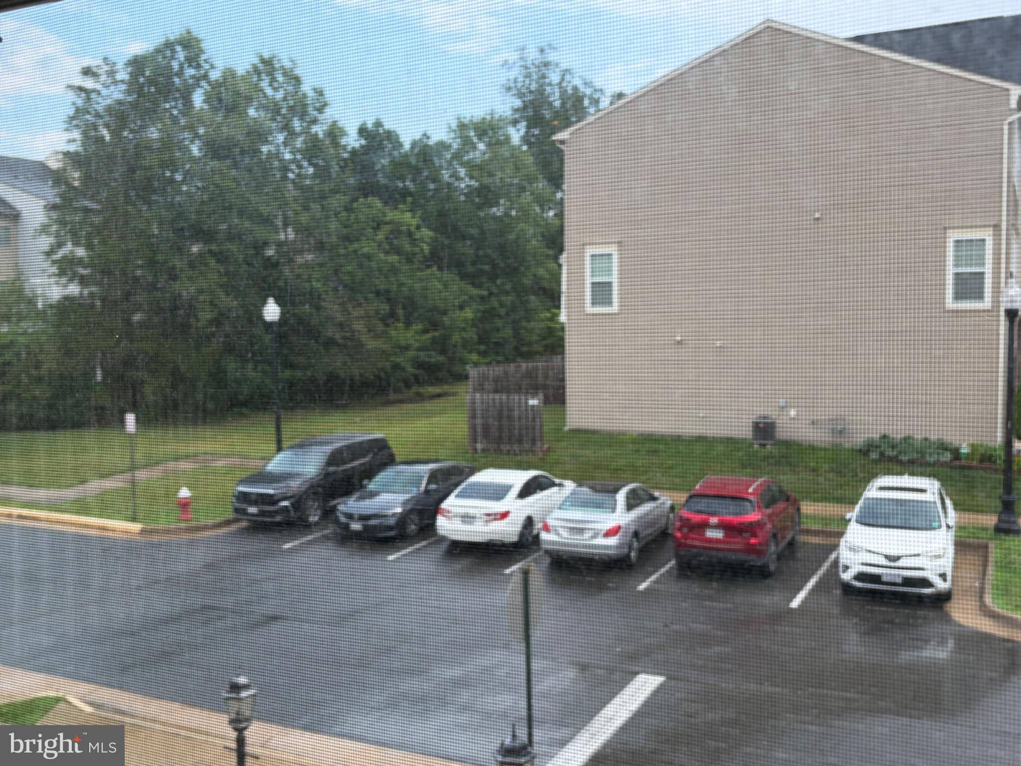 25333 Wakestone Terrace Chantilly, VA 20152 - Photo 31 of 109 Rainy day in a quiet parking lot.