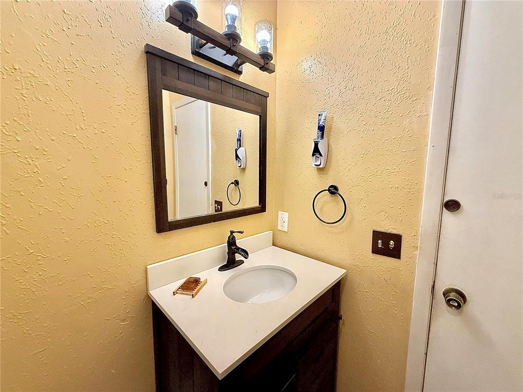 2500 Brook Road North Fort Meade, FL 33841 - Photo 13 of 65 a bathroom with a sink vanity and a mirror