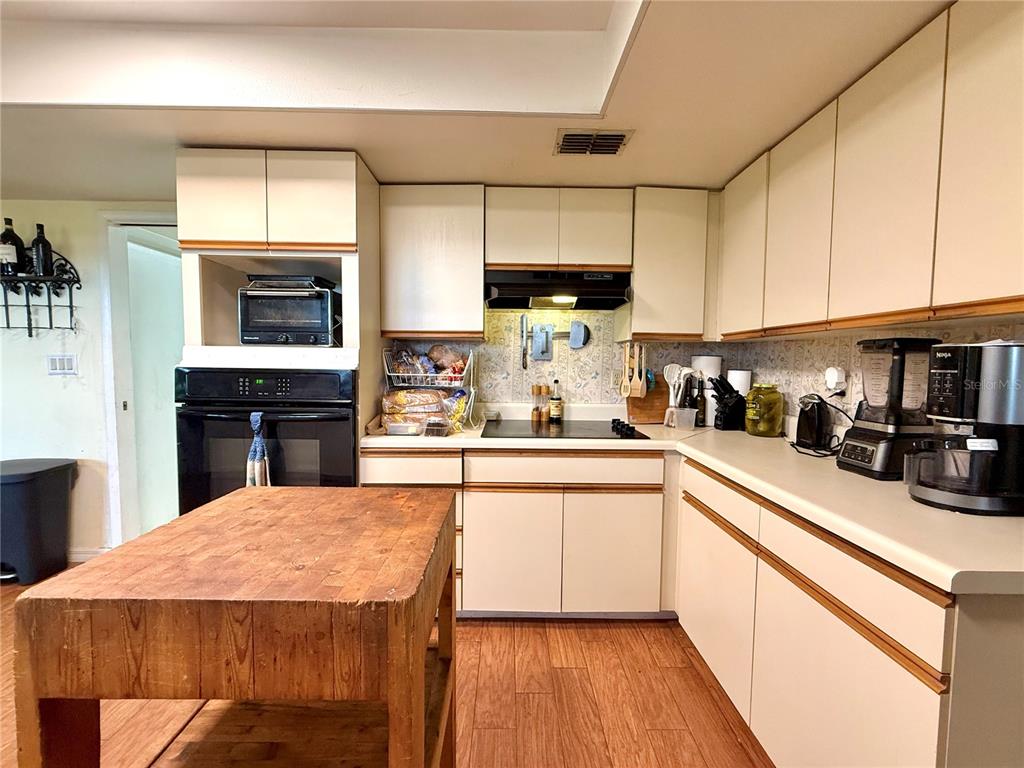 2500 Brook Road North Fort Meade, FL 33841 - Photo 18 of 65 a kitchen with a stove a sink a microwave and cabinets