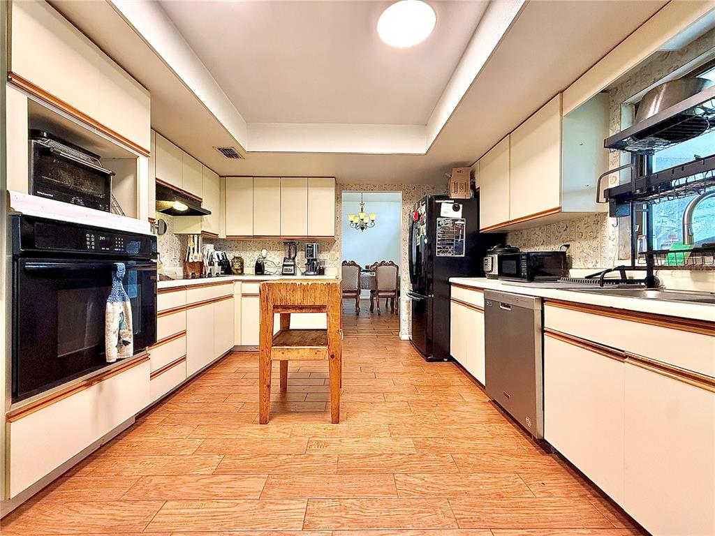 2500 Brook Road North Fort Meade, FL 33841 - Photo 21 of 65 a kitchen with stainless steel appliances kitchen island granite countertop a stove a sink dishwasher and a microwave oven with cabinets