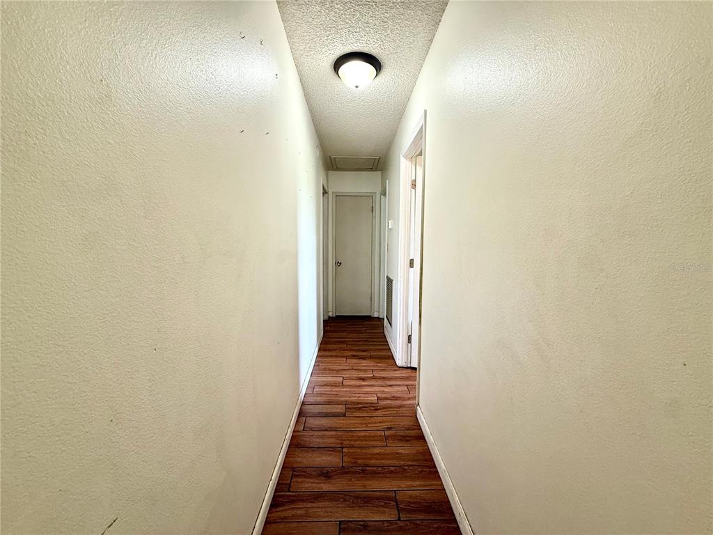 2500 Brook Road North Fort Meade, FL 33841 - Photo 23 of 65 a view of a hallway with wooden floor