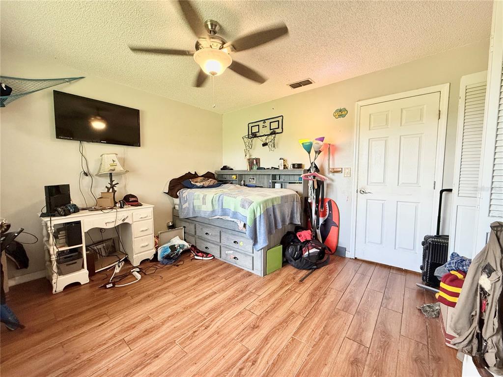 2500 Brook Road North Fort Meade, FL 33841 - Photo 39 of 65 a bedroom with bed and a flat tv screen on dresser
