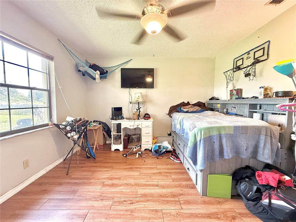 2500 Brook Road North Fort Meade, FL 33841 - Photo 40 of 65 a living room with furniture and a flat screen tv