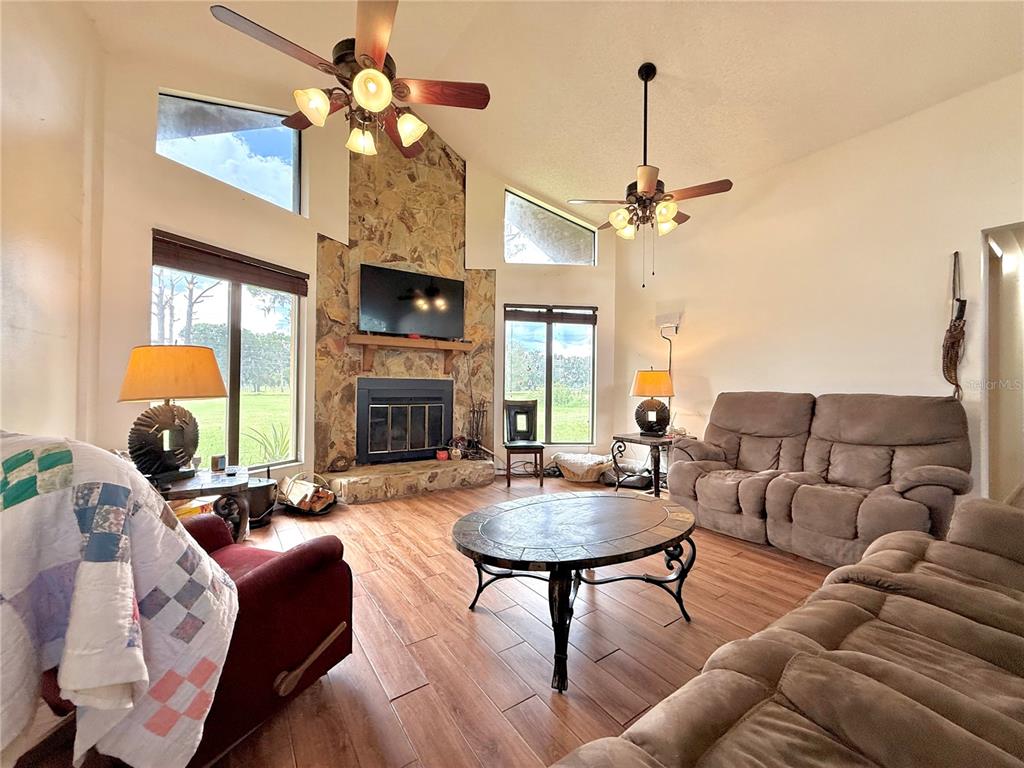 2500 Brook Road North Fort Meade, FL 33841 - Photo 6 of 65 a living room with furniture a fireplace and a chandelier