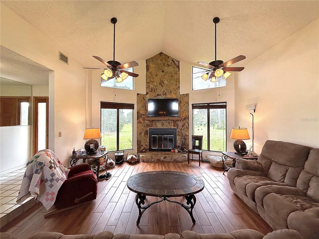 2500 Brook Road North Fort Meade, FL 33841 - Photo 7 of 65 a living room with furniture a chandelier and a fireplace