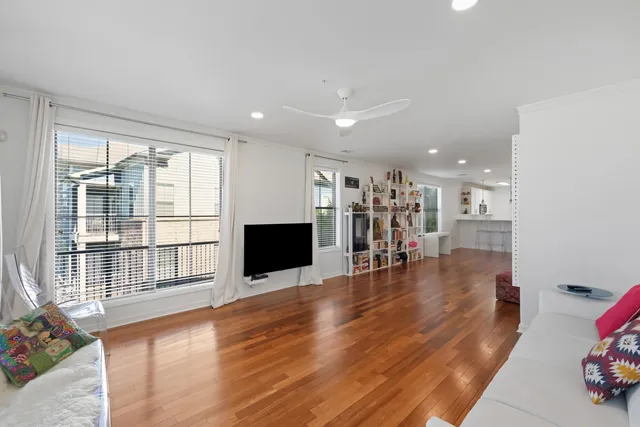 a view of empty room with wooden floor and fireplace