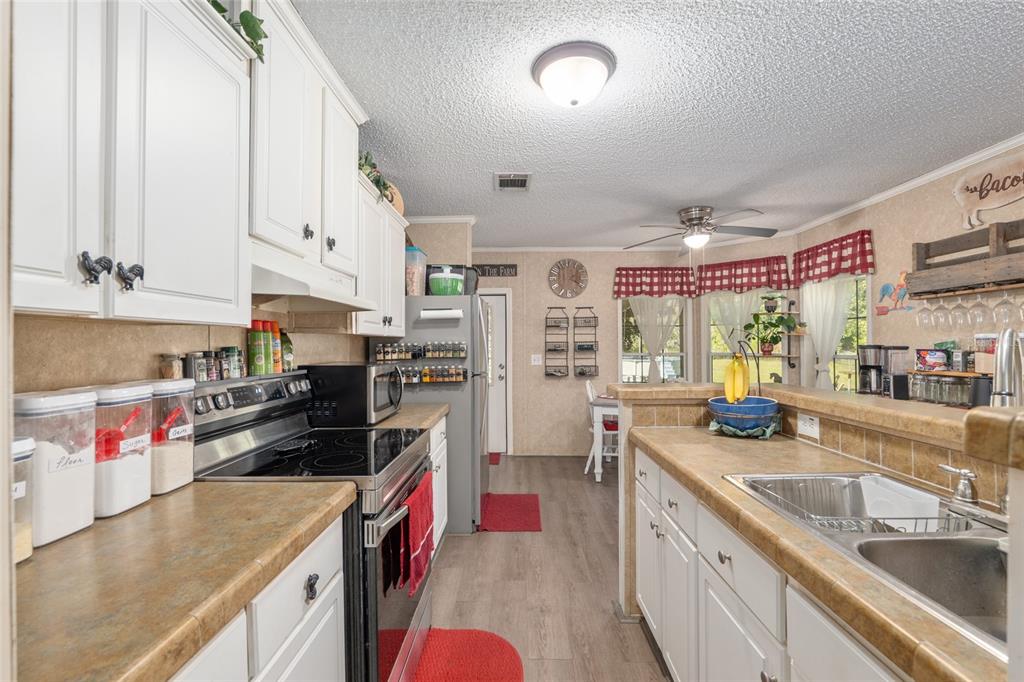 760 Southwest Barney Street High Springs, FL 32643 - Photo 14 of 57 a kitchen with kitchen island granite countertop lots of counter top space and stainless steel appliances