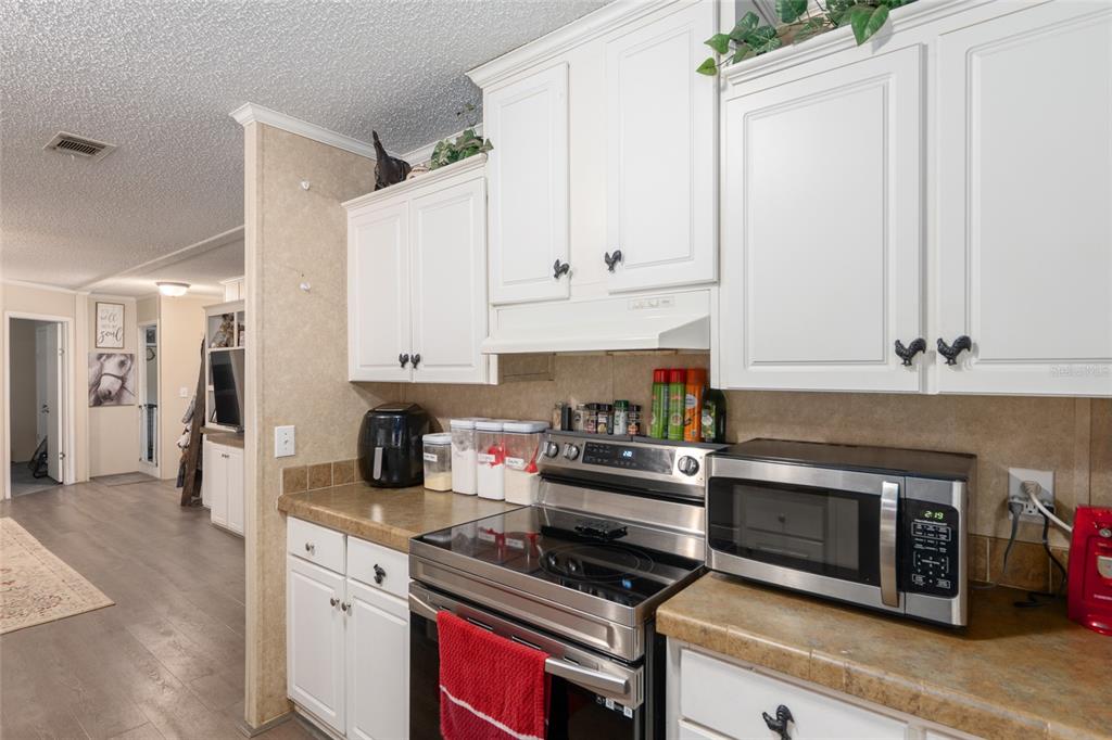 760 Southwest Barney Street High Springs, FL 32643 - Photo 16 of 57 a kitchen with stainless steel appliances a stove a white cabinets and a sink