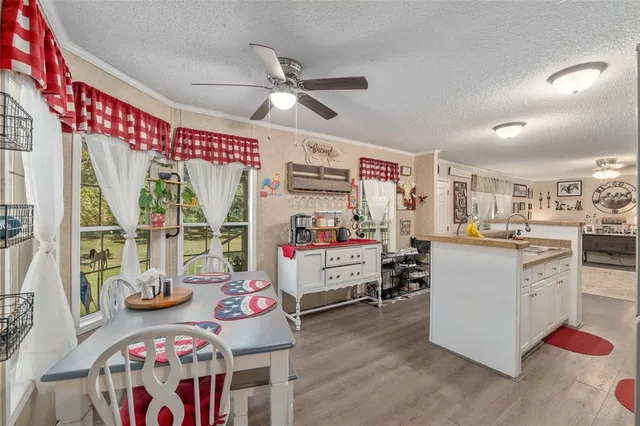 a kitchen with a refrigerator a stove top oven a counter space and wooden floor