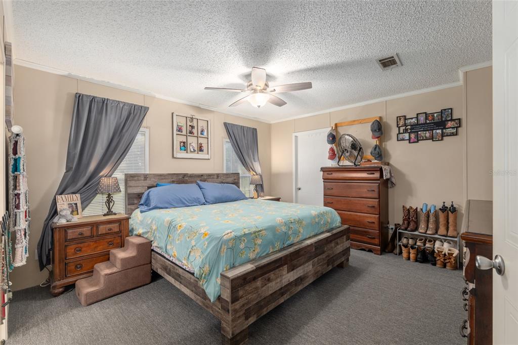 760 Southwest Barney Street High Springs, FL 32643 - Photo 21 of 57 a bedroom with a bed and a chandelier