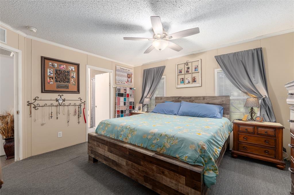 760 Southwest Barney Street High Springs, FL 32643 - Photo 22 of 57 a bedroom with a bed and a chandelier