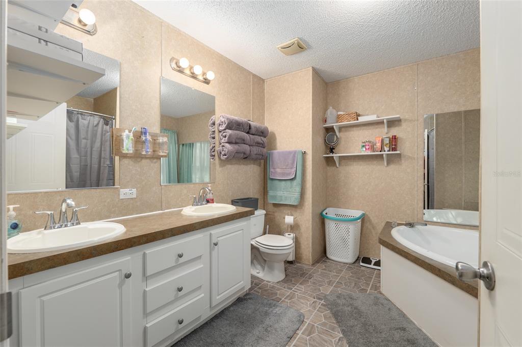760 Southwest Barney Street High Springs, FL 32643 - Photo 23 of 57 a spacious bathroom with a granite countertop sink toilet and shower