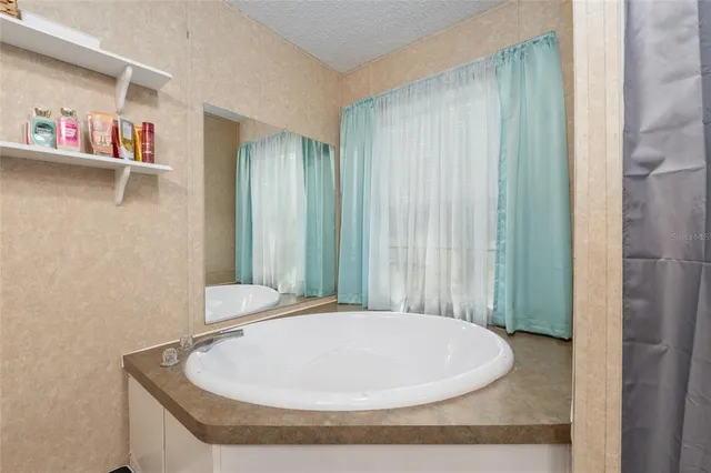 a view of walk in closet with clothes