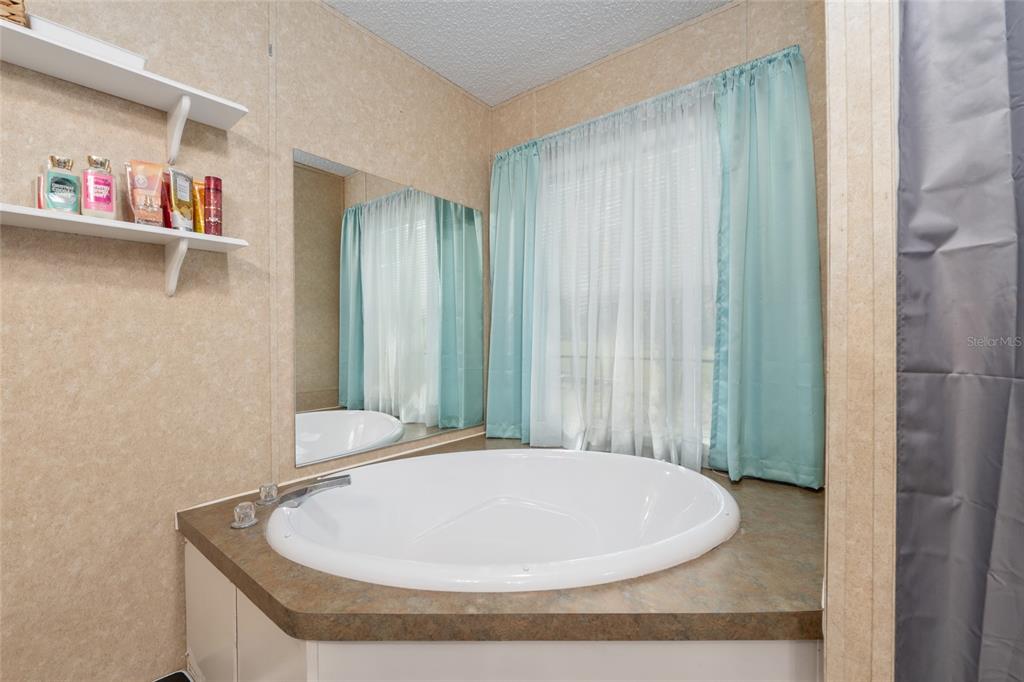 760 Southwest Barney Street High Springs, FL 32643 - Photo 24 of 57 a bathroom with a bathtub and a shower curtain