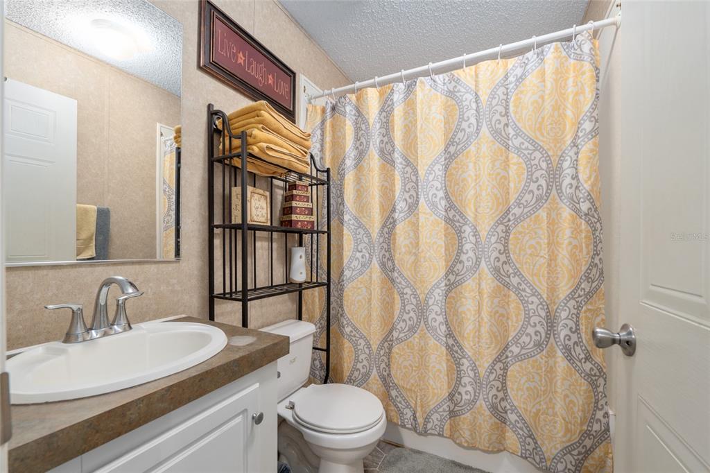 760 Southwest Barney Street High Springs, FL 32643 - Photo 29 of 57 a bathroom with a sink a toilet and a mirror