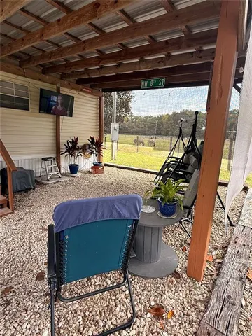 a view of a house with backyard swimming pool and sitting area