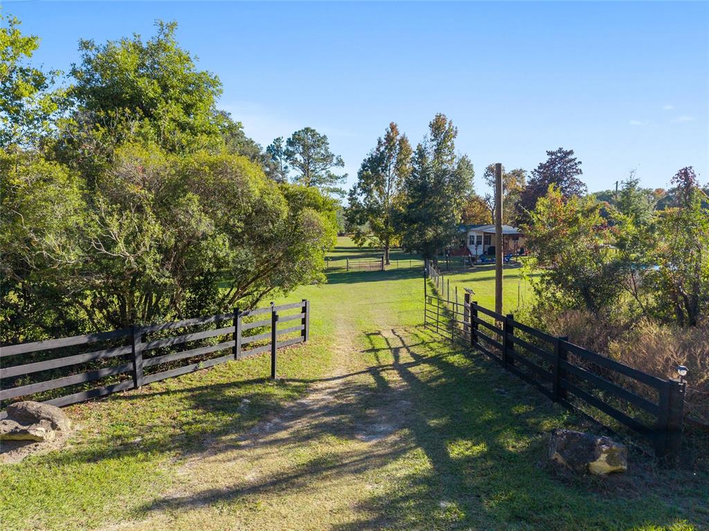 760 Southwest Barney Street High Springs, FL 32643 - Photo 49 of 57 a view of a lake with a yard and large trees