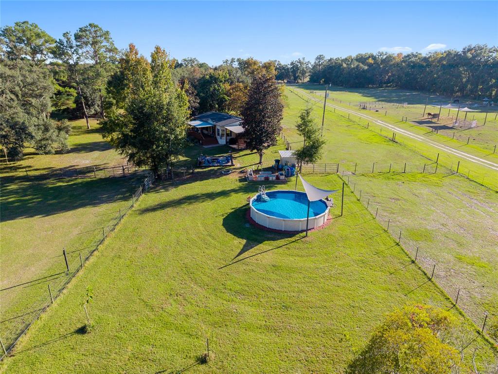 760 Southwest Barney Street High Springs, FL 32643 - Photo 52 of 57 a swimming pool with some trees in the background