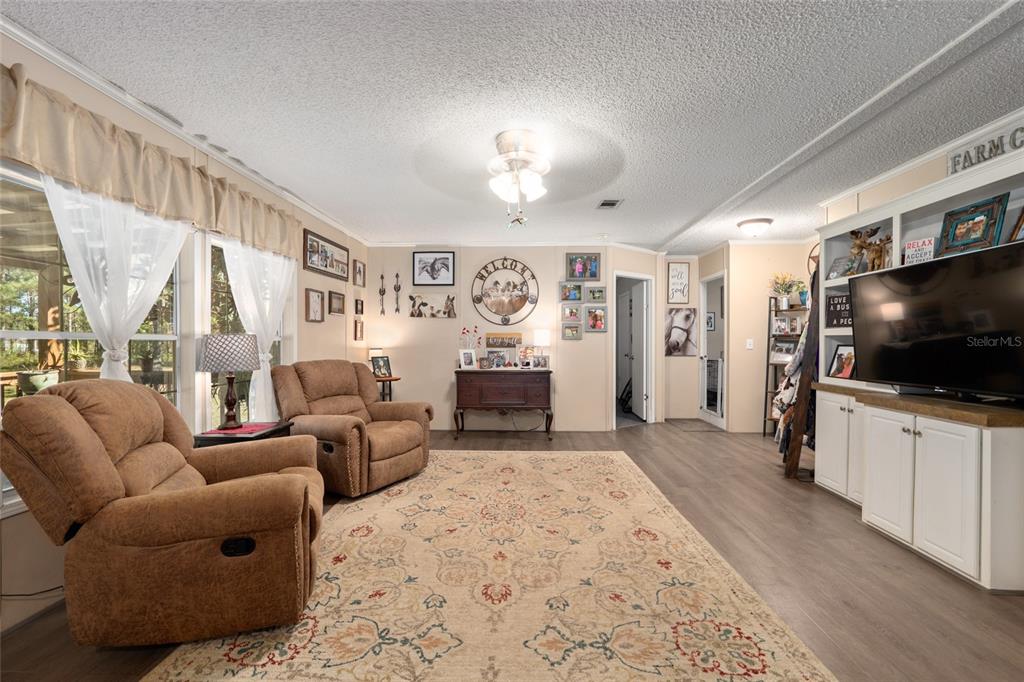 760 Southwest Barney Street High Springs, FL 32643 - Photo 10 of 57 a living room with furniture and a flat screen tv