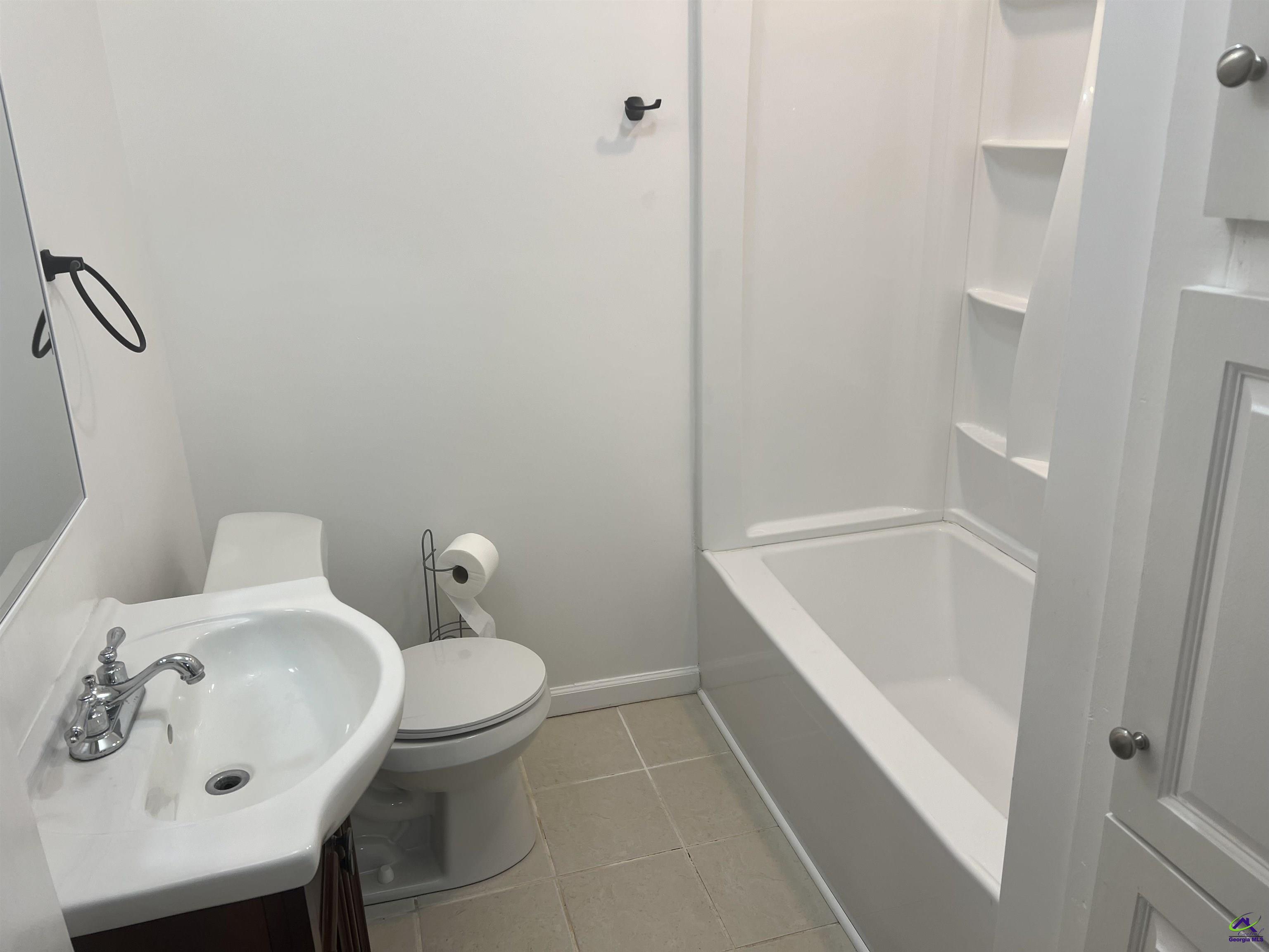 145 South 2nd Street Cochran, GA 31014 - Photo 24 of 24 a bathroom with a sink a toilet and shower