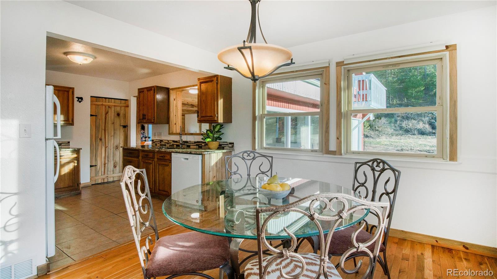 278 Jess-Mar Drive Shawnee, CO 80475 - Photo 13 of 40 a dining room with furniture a chandelier and wooden floor