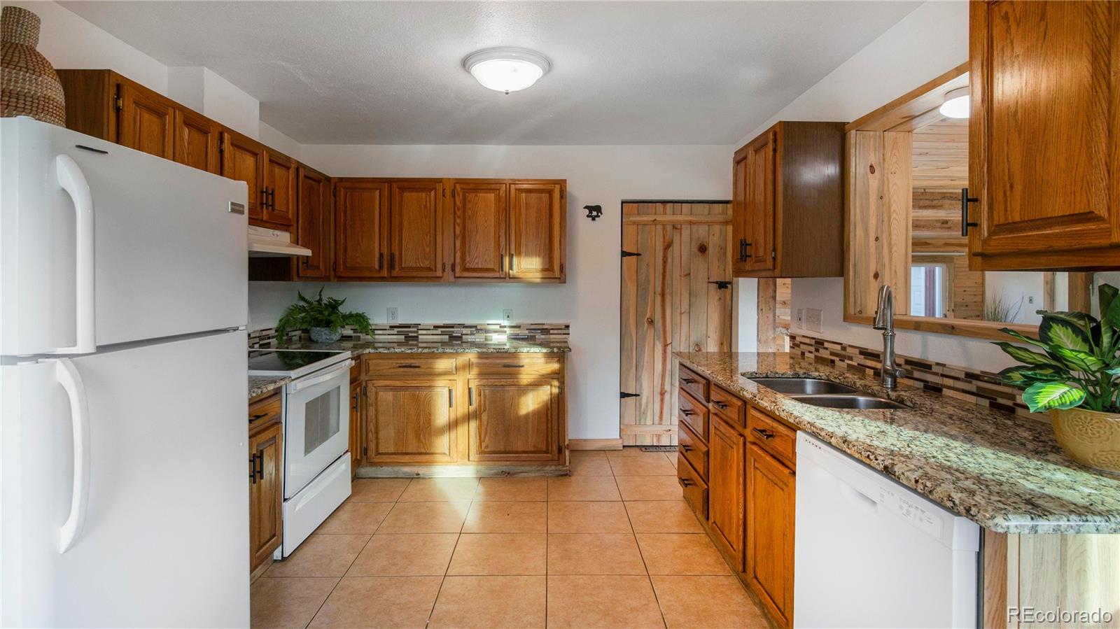 278 Jess-Mar Drive Shawnee, CO 80475 - Photo 14 of 40 a kitchen with stainless steel appliances granite countertop a refrigerator a stove and a sink