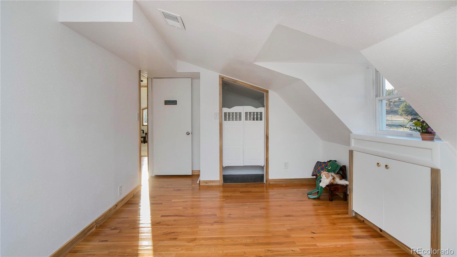 278 Jess-Mar Drive Shawnee, CO 80475 - Photo 33 of 40 a view of a room with wooden floor and stairs