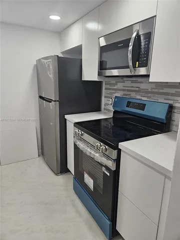 a kitchen with granite countertop cabinets and steel stainless steel appliances with cabinets