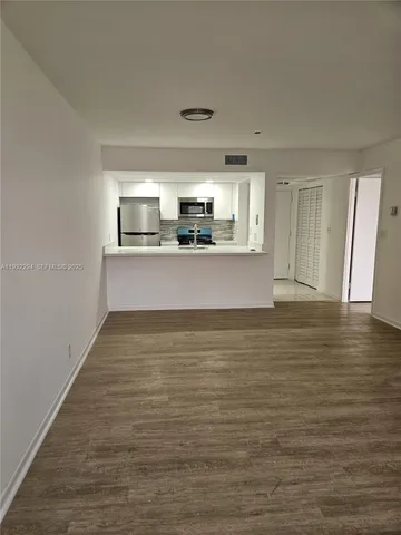 a view of kitchen and empty room