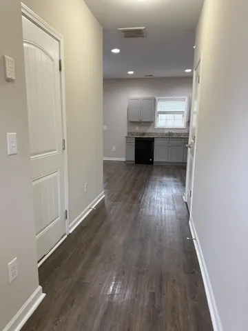 wooden floor in an empty room with a fireplace